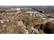 An aerial view shows a quaint home nestled among mature trees with the city skyline in the distance at 2107 Penrose Dr, Atlanta, GA 30344