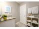 Bathroom featuring modern sink and shelving to hold towels and toiletries at 2107 Penrose Dr, Atlanta, GA 30344