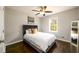 Bedroom features hardwood flooring, a ceiling fan, and a large sunny window at 2107 Penrose Dr, Atlanta, GA 30344