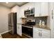 Well-equipped kitchen with stainless steel appliances, granite countertops, and ample cabinet space at 2107 Penrose Dr, Atlanta, GA 30344