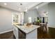 Open kitchen with granite countertops, stainless steel appliances, and views into the dining room at 2107 Penrose Dr, Atlanta, GA 30344