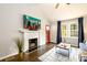 Bright living room with a fireplace, ceiling fan, hardwood floors, and natural light at 2107 Penrose Dr, Atlanta, GA 30344