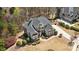 Aerial view of an elegant home with a well-manicured lawn, mature trees, and a long driveway at 305 Inman Pl, Roswell, GA 30075
