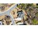 Bird's eye view of an upscale home with a large lawn, mature trees, and circular driveway in a quiet neighborhood at 305 Inman Pl, Roswell, GA 30075