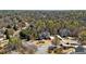 Scenic aerial view of a neighborhood featuring large, luxurious homes nestled among mature trees and lush landscaping at 305 Inman Pl, Roswell, GA 30075