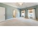 Spacious bedroom features an ensuite bathroom, two windows with custom window treatments, and neutral carpet at 305 Inman Pl, Roswell, GA 30075