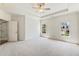 Bright bedroom with carpet and windows featuring neutral walls, and an adjoining bathroom at 305 Inman Pl, Roswell, GA 30075