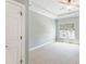 Bright, airy bedroom with carpet, neutral walls, and large window that provides natural light and outdoor views at 305 Inman Pl, Roswell, GA 30075