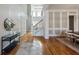 Spacious foyer with hardwood flooring, stairs, and adjacent dining area at 305 Inman Pl, Roswell, GA 30075