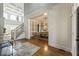 Grand foyer with high ceilings, hardwood floors, staircase, and entrance into dining room at 305 Inman Pl, Roswell, GA 30075