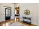 Elegant foyer with hardwood floors, decorative mirror, and access to other rooms at 305 Inman Pl, Roswell, GA 30075