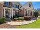 Charming home with brick facade, manicured landscaping, and inviting entryway at 305 Inman Pl, Roswell, GA 30075