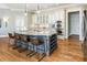 Kitchen island featuring barstool seating, a granite countertop, wine rack, and stainless steel appliances at 305 Inman Pl, Roswell, GA 30075
