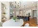 Open kitchen boasts an island with seating, granite countertops, stainless appliances, and hardwood floors at 305 Inman Pl, Roswell, GA 30075