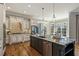 Updated kitchen with stainless steel appliances, granite countertops, and a large kitchen island with seating at 305 Inman Pl, Roswell, GA 30075