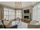 Cozy living room showcases a stone fireplace, large windows with blinds, and a gray sectional sofa at 305 Inman Pl, Roswell, GA 30075