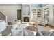 This spacious living room features a fireplace, built-in shelves and a comfortable seating arrangement at 305 Inman Pl, Roswell, GA 30075