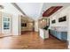 Entertaining living room with wet bar, hardwood floors, large windows, and multiple televisions at 305 Inman Pl, Roswell, GA 30075