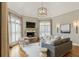Living room featuring a stone fireplace, hardwood floors, and a vaulted ceiling with neutral-toned furniture at 305 Inman Pl, Roswell, GA 30075