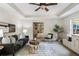 Inviting living room with staircase access, a comfortable sofa, stylish rug, and view of a bedroom at 305 Inman Pl, Roswell, GA 30075