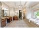 Luxurious main bathroom with double vanity, soaking tub, and walk-in shower at 305 Inman Pl, Roswell, GA 30075