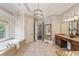 Elegant main bathroom featuring a soaking tub, double vanity, and decorative lighting at 305 Inman Pl, Roswell, GA 30075