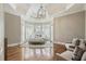 Bright main bedroom featuring a tray ceiling, hardwood floors, and bay window at 305 Inman Pl, Roswell, GA 30075