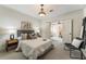 Comfortable main bedroom with open door leading to adjacent room with ceiling fan and light flooring at 305 Inman Pl, Roswell, GA 30075
