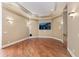 Cozy media room with hardwood floors, stylish trim, and mounted television for immersive entertainment at 305 Inman Pl, Roswell, GA 30075