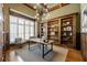Home office featuring custom built-ins, hardwood floors, and abundant natural light at 305 Inman Pl, Roswell, GA 30075