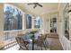 Covered back patio perfect for outdoor dining with a view of the lush backyard at 305 Inman Pl, Roswell, GA 30075