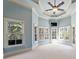 Bright sun room with ample natural light, neutral carpet, a ceiling fan, and backyard views at 305 Inman Pl, Roswell, GA 30075