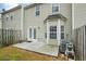 View of a cozy outdoor patio space with access to the house, enclosed by a wooden fence and greenery at 345 Timber Gate Court, Lawrenceville, GA 30045