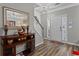 Welcoming home foyer with hardwood floors, elegant decor, and a view of the staircase and front door at 345 Timber Gate Court, Lawrenceville, GA 30045