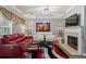 Comfortable living room featuring a fireplace, plush sofas, stylish decor, and natural light at 345 Timber Gate Court, Lawrenceville, GA 30045
