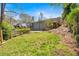 Backyard featuring a green lawn, wooden fence, and lush trees at 3819 Dora Se Dr, Smyrna, GA 30082