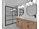 This bathroom features dual sinks and a black framed shower with a glass door at 3819 Dora Se Dr, Smyrna, GA 30082