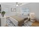 Staged bedroom featuring large windows, neutral paint, and refinished hardwoods at 3819 Dora Se Dr, Smyrna, GA 30082