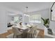 Dining room featuring hardwood floors, white walls, modern furniture, and stylish light fixture at 3819 Dora Se Dr, Smyrna, GA 30082