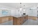 Spacious kitchen features an island with cooktop, stainless appliances, modern lighting, and ample counter space at 3819 Dora Se Dr, Smyrna, GA 30082