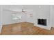 Bright living room features refinished hardwoods and a charming white brick fireplace at 3819 Dora Se Dr, Smyrna, GA 30082