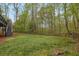 The lovely backyard has mature trees and a split rail fence running along the property line at 4495 Sagebrush Nw Dr, Kennesaw, GA 30152