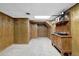 Finished basement with wood paneling, storage, and carpet, offering a versatile space for various activities at 4495 Sagebrush Nw Dr, Kennesaw, GA 30152