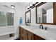Bathroom features a granite double vanity, modern lighting, and a window providing natural light at 4495 Sagebrush Nw Dr, Kennesaw, GA 30152