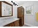 Bathroom featuring a marble countertop sink, lighting fixture, window, and dark wood cabinet at 4495 Sagebrush Nw Dr, Kennesaw, GA 30152