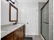 Bathroom features a granite double vanity, modern lighting, and a glass enclosed shower at 4495 Sagebrush Nw Dr, Kennesaw, GA 30152