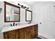 Bathroom features a granite double vanity, modern lighting, and a doorway to the shower at 4495 Sagebrush Nw Dr, Kennesaw, GA 30152