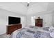 This bedroom features neutral walls, a ceiling fan, and a decorative dresser with a large TV at 4495 Sagebrush Nw Dr, Kennesaw, GA 30152