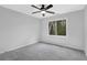 Spacious bedroom with neutral carpet and paint, ceiling fan, and a large window at 4495 Sagebrush Nw Dr, Kennesaw, GA 30152
