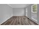 Bright, empty room with light gray walls, white trim, and sleek hardwood floors at 4495 Sagebrush Nw Dr, Kennesaw, GA 30152